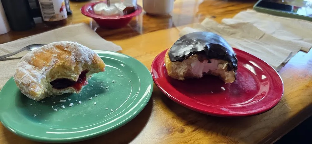 Donut on Left Is Raspberry Filled Donut One on Right Is a Cream Filled Chocolate Toped Donut